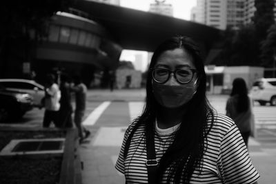 Portrait of young woman in city