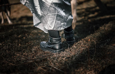 Low section of man standing on field