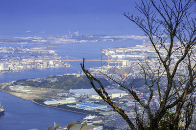 High angle view of city by sea against sky