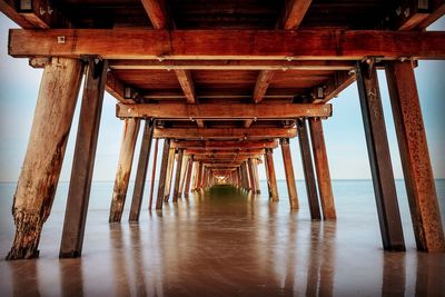 Silhouette of pier on beach