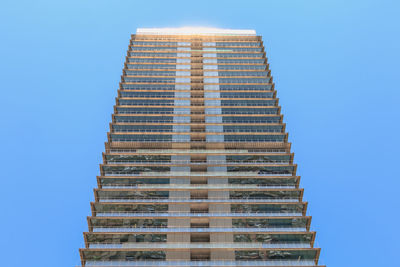 Low angle view of building against clear blue sky