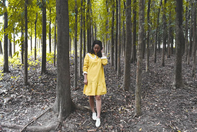 Full length of a man standing in forest