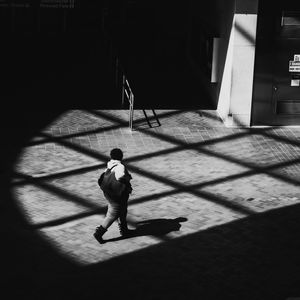 High angle view of man walking on floor