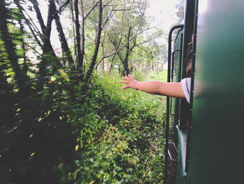 Midsection of man by train on land