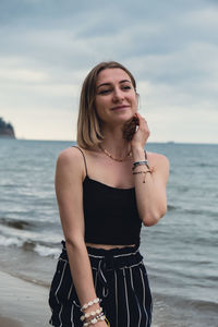 Young woman standing at beach