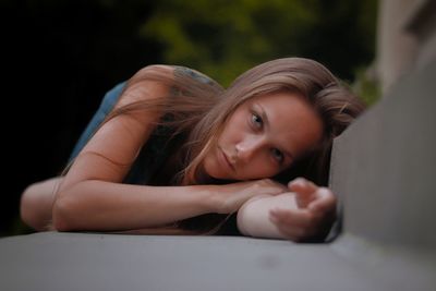 Portrait of a beautiful young woman lying down