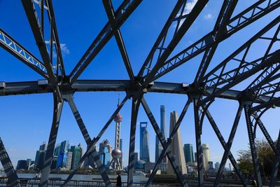 Low angle view of bridge against blue sky