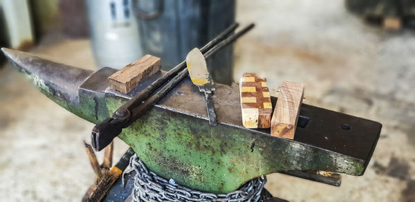 High angle view of metallic structure on wood