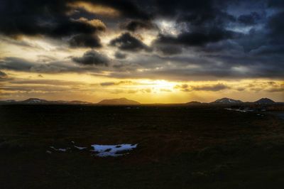 Scenic view of mountains against dramatic sky