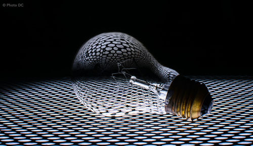 Close-up of electric fan against black background