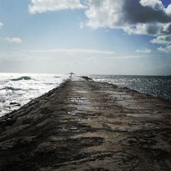 Pier over sea against sky