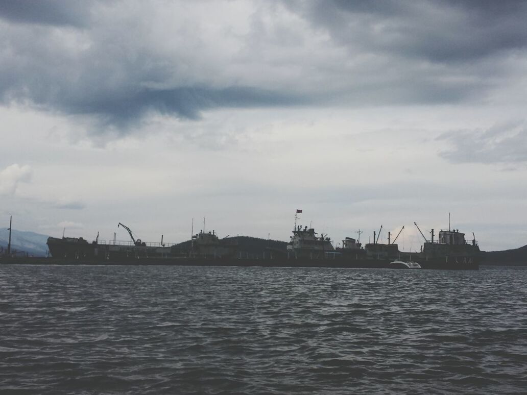 water, waterfront, sky, sea, built structure, cloud - sky, architecture, nautical vessel, building exterior, harbor, rippled, transportation, cloudy, cloud, river, nature, commercial dock, mode of transport, tranquility, boat