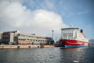 Ship moored at harbor against sky