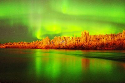 Scenic view of lake against sky at night