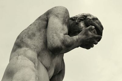 Low angle view of male sculpture against clear sky