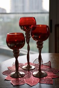 Close-up of red wine glasses on table