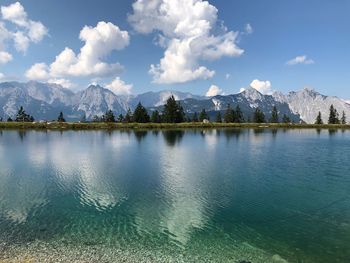 Panoramic view of lake by mountains against sky