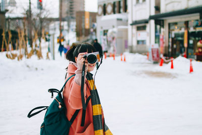 Man photographing with snow