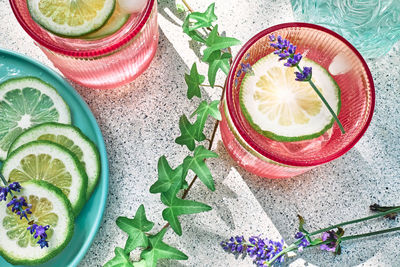 Cool lavender lemonade with lime slices and lavender flower on the table. top view. 