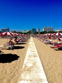 Scenic view of beach against clear blue sky