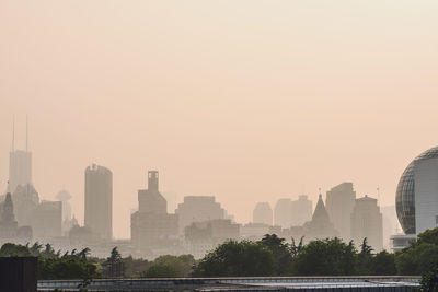 Cityscape against clear sky during sunset