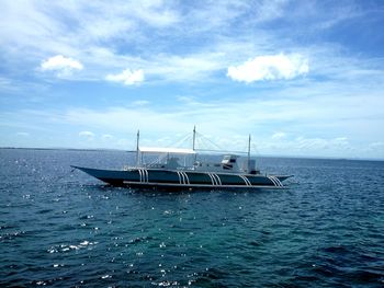 Sailboat in sea against sky