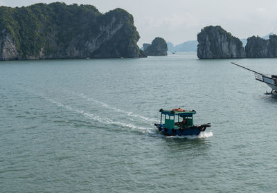 Boat sailing in sea against sky