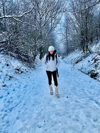Person walking on snow covered footpath