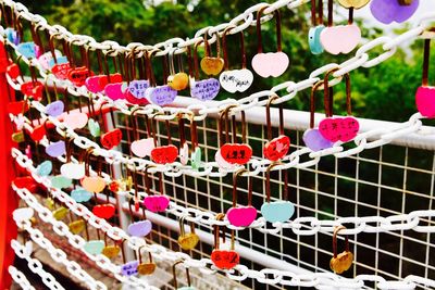 Close-up of colorful padlocks hanging on railing