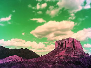 High section of mountain against cloudy sky