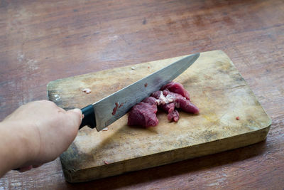 High angle view of person preparing food on cutting board