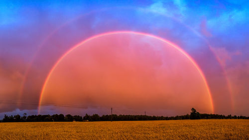 Scenic view of rainbow against sky during sunset