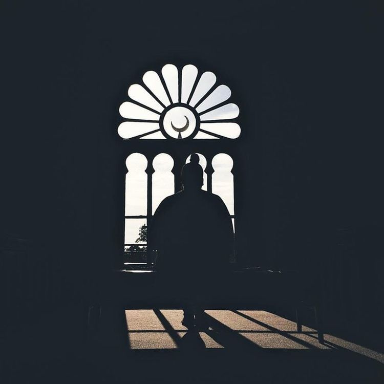 MAN IN ILLUMINATED CORRIDOR