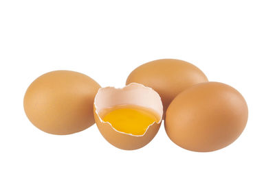 Close-up of broken egg against white background