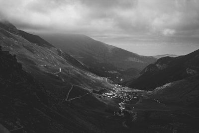 Scenic view of mountains against cloudy sky