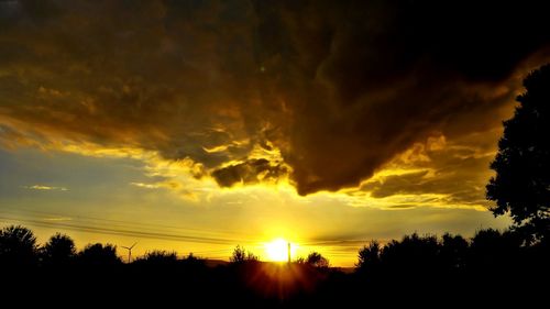 Silhouette of landscape against cloudy sky