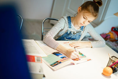 Boy sitting on table