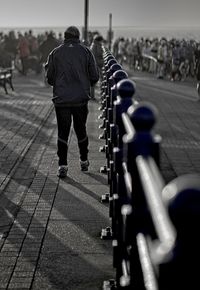 Rear view of people walking on street