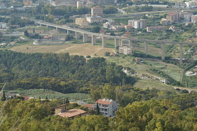 High angle view of buildings and trees in city