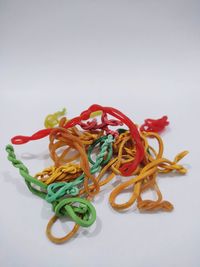 High angle view of multi colored candies on white background