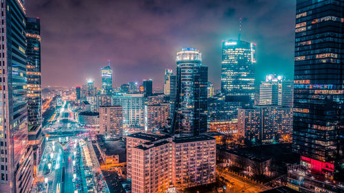 Aerial view of city lit up at night