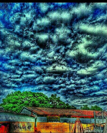 sky, cloud - sky, cloudy, low angle view, built structure, architecture, building exterior, cloud, weather, overcast, multi colored, house, outdoors, roof, auto post production filter, blue, no people, dramatic sky, nature, high section