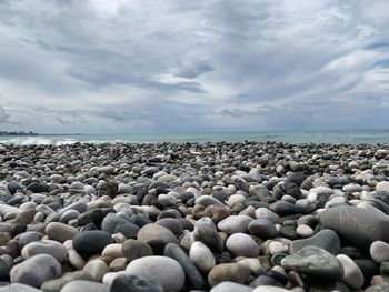 Rocks on beach against sky