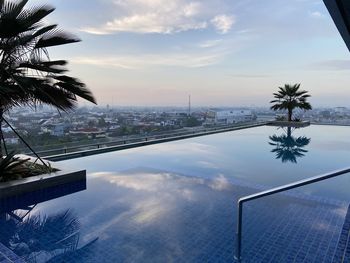 View of swimming pool against cloudy sky