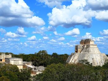 Uxmal ruins against cloudy sky