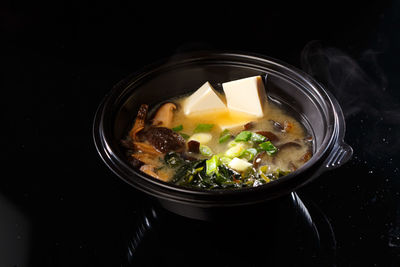 High angle view of food in bowl against black background