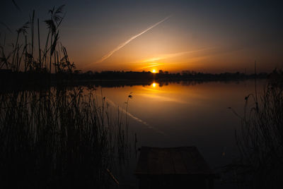 Scenic view of lake against sky during sunset