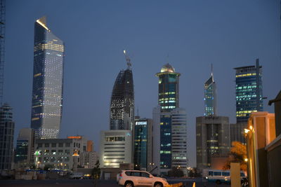 Illuminated cityscape against sky at night