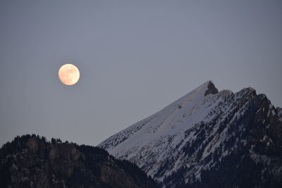 Low angle view of moon against clear sky at night