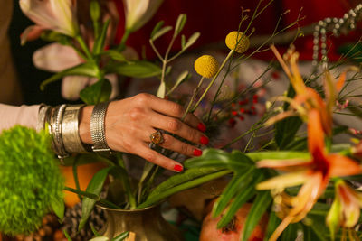 Midsection of woman holding flowering plants